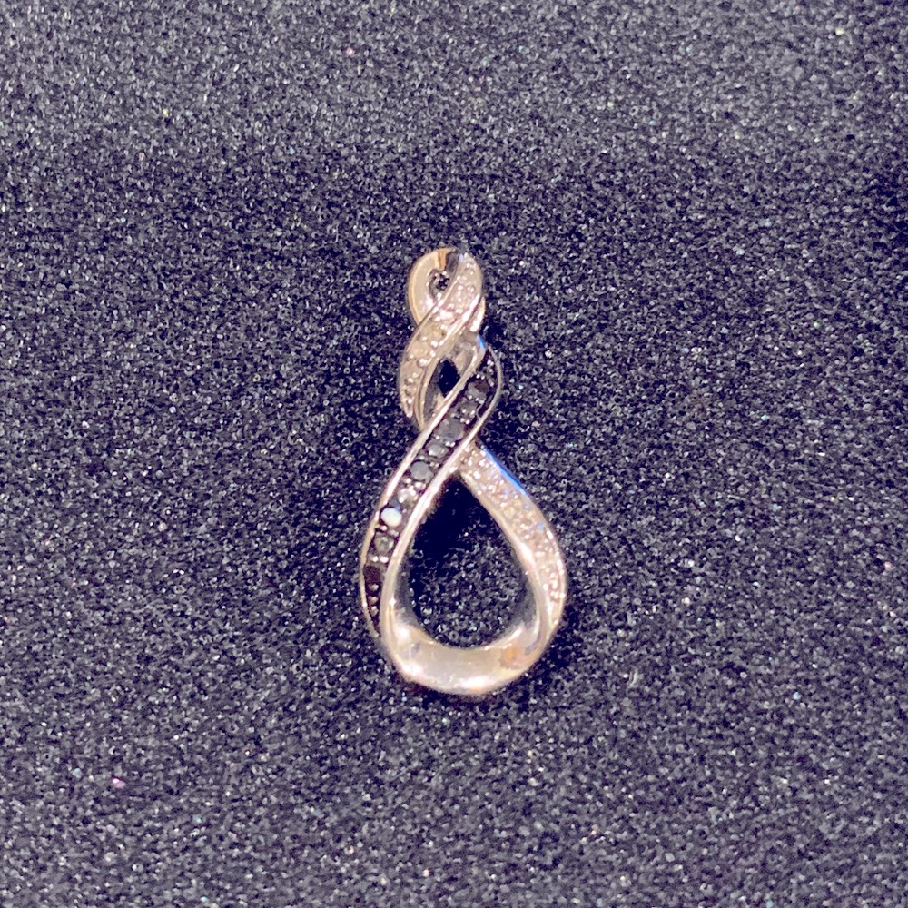 Sterling silver. Infinity-style diamond pendant.